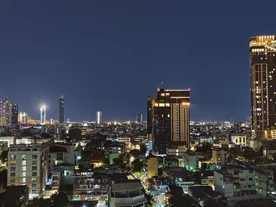 a city skyline at night with tall buildings at The Central Bangkok Station1 in Bangkok