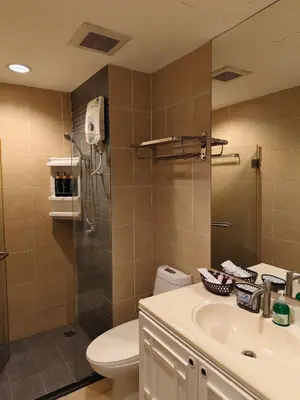 a bathroom with a toilet and a sink and a shower at The Central Bangkok Station1 in Bangkok