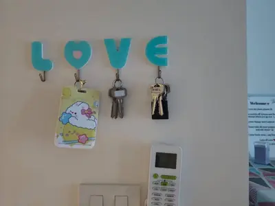 a wall with keys and a sign that reads love at A family room at Lumpini Ville Sukhumvit 101-1 by Pikul in Bangkok