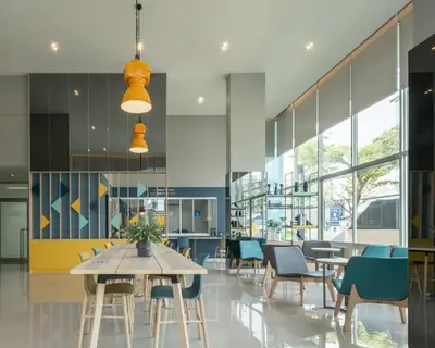 a dining room with tables and chairs and windows at A family room at Lumpini Ville Sukhumvit 101-1 by Pikul in Bangkok