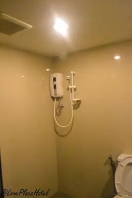 a shower stall in a bathroom with a toilet at Sixty Star Love Place Hotel in Bangkok
