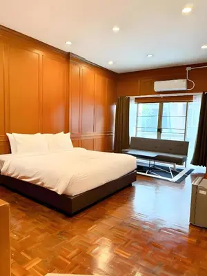 a bedroom with a bed and a bench in it at xx Stay On Sukhumvit 11 BTS Nana in Bangkok