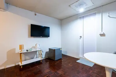 a living room with a tv and a table at xx Stay On Sukhumvit 11 BTS Nana in Bangkok