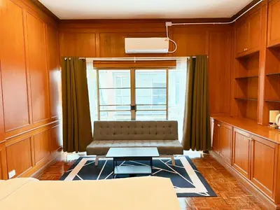 a living room with a couch and a window at xx Stay On Sukhumvit 11 BTS Nana in Bangkok