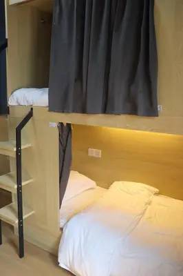 a bedroom with a bunk bed and a window at The Moment Hostel in Bangkok