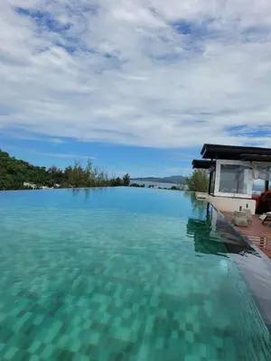 a swimming pool with a view of the water at Appartement douillet pool fitness in Bangkok