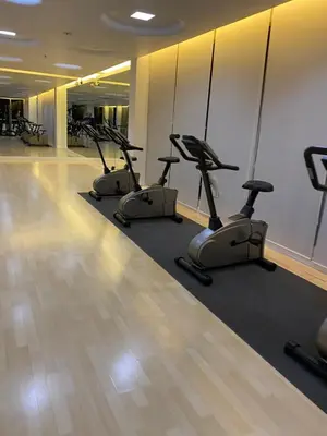 a row of exercise bikes in a gym at Appartement douillet pool fitness in Bangkok