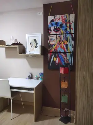 a room with a desk and a painting on the wall at Appartement douillet pool fitness in Bangkok