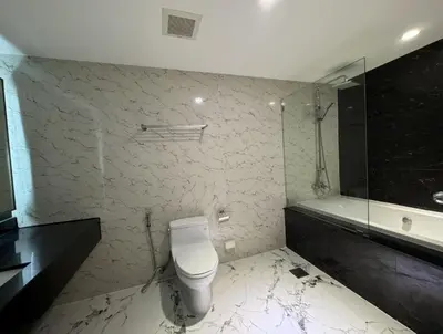a bathroom with a toilet and a glass shower at NEW 1 bedroom 46FL Bangrak City view in Chinatown