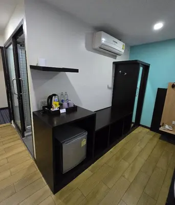 a kitchen with a black counter and a refrigerator at Residency Hotel Bangkok in Bangkok