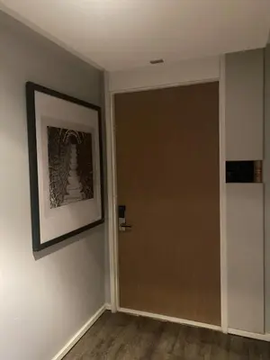 a door in a room with a picture on the wall at Mövenpick Residence Ekkamai in Sathani Khlong Tan
