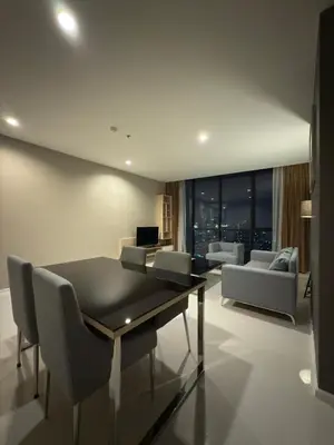 a living room with a table and chairs and a couch at Mövenpick Residence Ekkamai in Sathani Khlong Tan