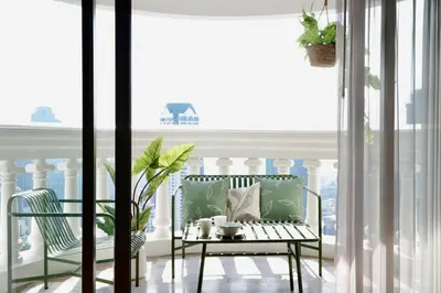 a balcony with a bench and a table and a window at BangrakHomey - Cozy private Apartment in State tower bangkok in Bangkok