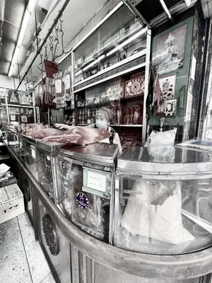 a woman standing behind a counter in a store at BangrakHomey - Cozy private Apartment in State tower bangkok in Bangkok