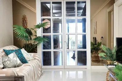 a living room with a large glass door at BangrakHomey - Cozy private Apartment in State tower bangkok in Bangkok