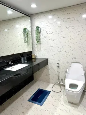 a bathroom with a toilet and a sink and a mirror at BangrakHomey - Cozy private Apartment in State tower bangkok in Bangkok