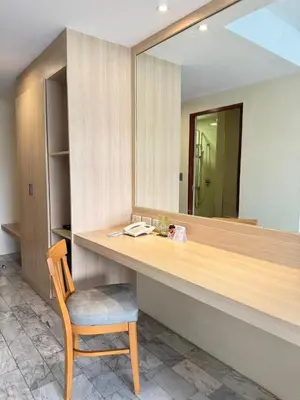 a desk with a chair and a mirror at iCheck inn Thapra in Bangkok