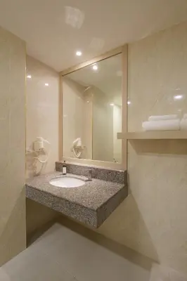 a bathroom with a sink and a large mirror at iCheck inn Thapra in Bangkok