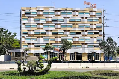 a large apartment building with a statue in front of it at The Publyc Hotel in Bangna
