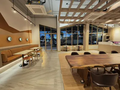 a conference room with tables and chairs and windows at The Publyc Hotel in Bangna