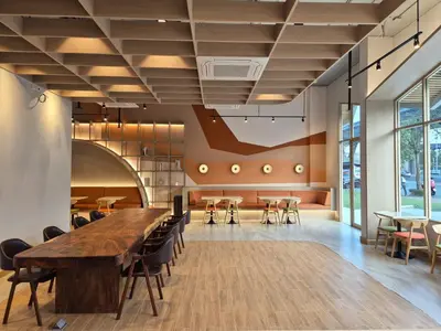 a large conference room with a large wooden table and chairs at The Publyc Hotel in Bangna
