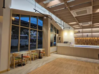 a lobby of a restaurant with tables and chairs at The Publyc Hotel in Bangna