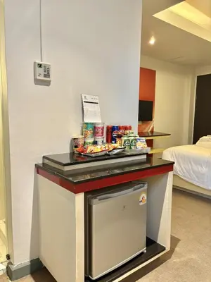 a hotel room with a counter with food on it at Klassique Sukhumvit Hotel in Bangkok