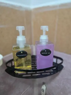 two bottles of soap on a shelf in a bathroom at 104 Peaceful and Cosy apartment near BTS with free WiFi in Bangkok