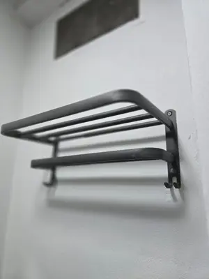 a black towel rack on a white wall at 104 Peaceful and Cosy apartment near BTS with free WiFi in Bangkok