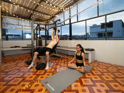 a man and a woman doing pilates in a gym at OH Hostels - Bangkok in Bangkok