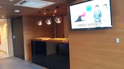 a tv on a wall in a room at Sereine Sukhumvit 39 in Bangkok
