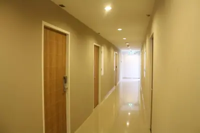 an empty hallway with a door and a hallway at Sereine Sukhumvit 39 in Bangkok