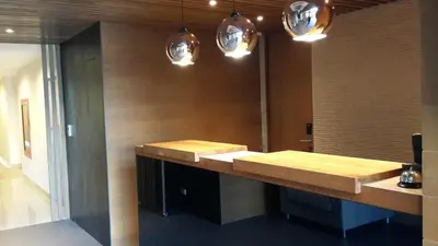 a bathroom with a wooden counter and pendant lights at Sereine Sukhumvit 39 in Bangkok