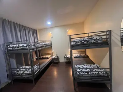 a room with three bunk beds in it at \u5e0c\u671b\u66f4\u597d\u6c11\u5bbf in Bang Rak