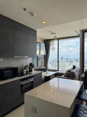 a kitchen and living room with a view of the city at The Esse Asoke in Bangkok