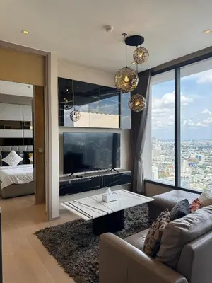 a living room with a couch and a table at The Esse Asoke in Bangkok