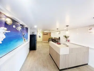 an office lobby with a reception desk and a large painting at Youjia Youth Hostel in Bang Rak