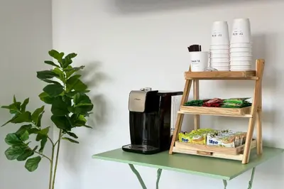 a shelf with a coffee maker on a table at Shade House Bangkok Oldtown in Bangkok
