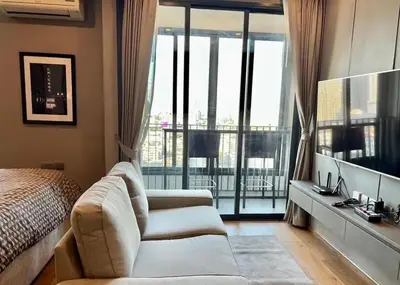a bedroom with a couch and a bed and a balcony at Condo Luxe Siam Pool 360 Near BTS Shopping in Bangkok