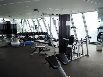 a gym with treadmills and machines in a building at Condo Luxe Siam Pool 360 Near BTS Shopping in Bangkok