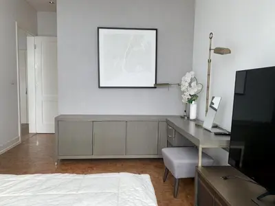 a room with a desk and a picture on the wall at Ritz Carlton Residences in Bangkok
