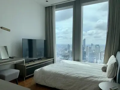 a hotel room with a bed and a large window at Ritz Carlton Residences in Bangkok