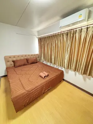 a bedroom with a large bed in a room at Impact - Don Mueng Condo C5 in Thung Si Kan