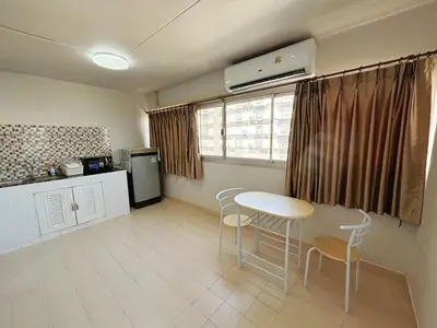 a kitchen with a table and chairs in a room at Impact - Don Mueng Condo C5 in Thung Si Kan