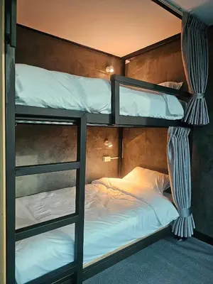 a couple of bunk beds in a room at บ้านรังนก The Bird Nest Homestay & Coffeeshop in Samut Prakan