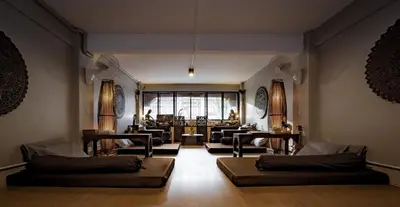 a living room with two couches and a living room with at Mind Day Hostel Khaosan in Bangkok
