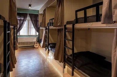 a room with several bunk beds in a room at Mind Day Hostel Khaosan in Bangkok