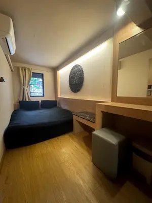 a living room with a blue couch in a room at Mind Day Hostel Khaosan in Bangkok