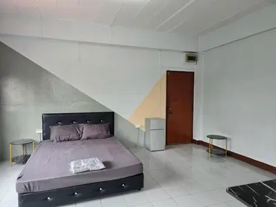 a bedroom with a bed and two stools at SRINN House, Bangkok in Bangkok