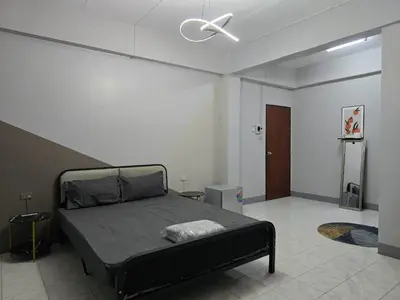 a bedroom with a bed and a ceiling fan at SRINN House, Bangkok in Bangkok